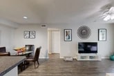 Located at 101 Porpoise Bay Road in Daytona Beach, FL, this well-appointed two-bedroom, two-bathroom single-floor residence offers a practical and comfortable layout. The open-concept living and dining area serves as the heart of the home, featuring rich wood-look flooring, neutral-toned walls, a textured ceiling, and a ceiling fan that enhances airflow. The living space is bright and inviting, providing ample room for both relaxing and entertaining.

The galley-style kitchen is efficiently designed with ample cabinetry, dark granite-style countertops, and full appliances including a range, dishwasher, and refrigerator. It connects seamlessly to a utility room housing a dedicated in-unit washer and dryer.

Both hallways are lined with louvered closet doors, offering generous storage throughout. The bedrooms feature plush carpeting and ceiling fans, with the primary bedroom benefiting from a large window that invites natural light. Four closets in total ensure excellent storage capacity.

The two bathrooms are finished with wood-look flooring, vanities with granite-style countertops, and tub/shower combinations. A private patio extends the living space outdoors. The overall ambiance is clean, functional, and move-in ready.
