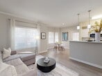 Located in Conroe, TX, this single-story, three-bedroom, three-bathroom residence offers a well-designed layout that maximizes comfort and functionality. The open-concept living and dining area is bright and airy, featuring light hardwood-style flooring, crown molding, and an abundance of natural light streaming through large windows dressed with elegant blinds and curtains. The living room flows seamlessly into the dining area, which connects directly to a kitchen peninsula, ideal for everyday living and entertaining.

The galley-style kitchen is equipped with white cabinetry, stainless steel appliances, a subway tile backsplash, and a double basin sink — offering ample storage and prep space. Each of the three bedrooms features plush carpeting, ceiling fans, and generous closet space, including walk-in options. The primary bedroom is a comfortable retreat with dedicated closet storage. The bathrooms are clean and functional, featuring dual-mirror vanities with white countertops, tile flooring, and modern fixtures.

Two hallways connect the living spaces to the private quarters, and a patio provides an outdoor extension of the home. Crown molding and consistent neutral tones throughout create a cohesive, polished aesthetic.