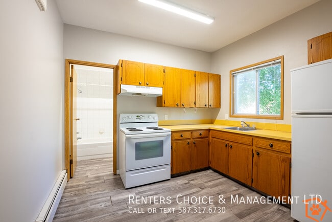 Building Photo - MAIN FLOOR UNIT With Assigned Parking and ...