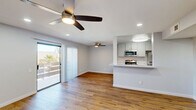 Located at 2925 Escoba Drive in Palm Springs, CA, this single-story 2-bedroom, 2-bathroom residence offers a well-designed layout with modern finishes throughout. The heart of the home is a combined living, dining, and kitchen area that flows seamlessly together. The kitchen features stainless steel appliances including a refrigerator, range, microwave, and dishwasher, complemented by sleek gray cabinetry, light granite-style countertops, a double stainless steel sink with a flexible-head faucet, and a peninsula that opens to the living space. Warm wood-tone hardwood flooring runs throughout the home, adding continuity and character. The living area is bright and airy, with ceiling fans, recessed lighting, and a sliding glass door that leads to a private balcony. The spacious primary bedroom includes recessed lighting, a ceiling fan, and ample closet space. The second bedroom features a ceiling fan, natural light from a window with vertical blinds, and its own closet. Two full bathrooms serve the home—one with a glass-enclosed shower and one with a full tub-shower combination. Additional closets and a utility room provide generous storage. The clean, neutral palette and updated finishes give the space a fresh, move-in-ready appeal ideal for the Palm Springs lifestyle.