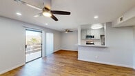 Located at 2925 Escoba Drive in Palm Springs, CA, this single-story 2-bedroom, 2-bathroom residence offers a well-designed layout with modern finishes throughout. The heart of the home is a combined living, dining, and kitchen area that flows seamlessly together. The kitchen features stainless steel appliances including a refrigerator, range, microwave, and dishwasher, complemented by sleek gray cabinetry, light granite-style countertops, a double stainless steel sink with a flexible-head faucet, and a peninsula that opens to the living space. Warm wood-tone hardwood flooring runs throughout the home, adding continuity and character. The living area is bright and airy, with ceiling fans, recessed lighting, and a sliding glass door that leads to a private balcony. The spacious primary bedroom includes recessed lighting, a ceiling fan, and ample closet space. The second bedroom features a ceiling fan, natural light from a window with vertical blinds, and its own closet. Two full bathrooms serve the home—one with a glass-enclosed shower and one with a full tub-shower combination. Additional closets and a utility room provide generous storage. The clean, neutral palette and updated finishes give the space a fresh, move-in-ready appeal ideal for the Palm Springs lifestyle.