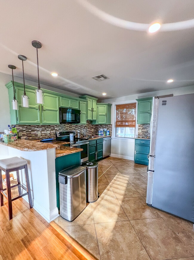 Kitchen with granite countertops and updated appliances - 5717 Pasteur Blvd