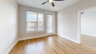 Unit A1-507 at 2307 N Tryon St in Charlotte, NC offers a compact and efficiently designed 590 square feet of single-floor living space. The open-concept layout combines the kitchen and living room into one cohesive area, maximizing functionality within the available footprint. Light-toned hardwood-style flooring runs throughout, lending warmth and visual continuity to the space. The living area is bright and airy, benefiting from a large window and a glass-panel door that invite natural light deep into the interior. A ceiling fan overhead provides both comfort and a polished finishing touch. Neutral gray walls provide a clean, versatile backdrop suited to a variety of décor styles. The private bedroom spans 120 square feet, offering a dedicated retreat within the unit. A single full bathroom completes the layout. The exterior-facing door suggests access to a balcony or outdoor area, adding to the unit's appeal. Situated in the North Tryon corridor, this apartment is well-positioned within a growing Charlotte neighborhood, making it a practical choice for those seeking urban convenience in a manageable, modern living space.