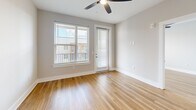 Unit A1-507 at 2307 N Tryon St in Charlotte, NC offers a compact and efficiently designed 590 square feet of single-floor living space. The open-concept layout combines the kitchen and living room into one cohesive area, maximizing functionality within the available footprint. Light-toned hardwood-style flooring runs throughout, lending warmth and visual continuity to the space. The living area is bright and airy, benefiting from a large window and a glass-panel door that invite natural light deep into the interior. A ceiling fan overhead provides both comfort and a polished finishing touch. Neutral gray walls provide a clean, versatile backdrop suited to a variety of décor styles. The private bedroom spans 120 square feet, offering a dedicated retreat within the unit. A single full bathroom completes the layout. The exterior-facing door suggests access to a balcony or outdoor area, adding to the unit's appeal. Situated in the North Tryon corridor, this apartment is well-positioned within a growing Charlotte neighborhood, making it a practical choice for those seeking urban convenience in a manageable, modern living space.