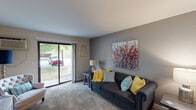 This single-floor residence in Wyoming, Michigan offers a thoughtfully designed layout that balances comfort and functionality. The living room is carpeted and filled with natural light streaming through a large sliding glass door that opens to an outdoor view, creating an airy, welcoming atmosphere. The space is complemented by neutral gray walls and room for stylish furnishings.

Adjacent to the living area, the kitchen features wood-look flooring, granite-style countertops, white cabinetry, and stainless steel appliances, providing a practical and attractive space for cooking and meal prep. A cozy dining area sits nearby with hardwood-style flooring and access to the main entry, making it ideal for casual dining.

The bedroom is generously sized with plush carpeting, a large closet, and a window that allows natural light to filter in, contributing to a calm and restful environment. The full bathroom includes a granite-topped vanity with white cabinetry, a combined tub and shower, and clean, neutral finishes throughout.

The overall design of the home features a consistent neutral color palette, durable mixed flooring, and a practical single-level floor plan that flows seamlessly from one room to the next, making it a comfortable and easy-to-navigate living space.