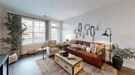 This contemporary 670 square foot apartment in Hickory, NC offers a perfect blend of style and functionality. The open-concept design creates a seamless flow between the living areas, maximizing the use of space. The modern kitchen boasts white cabinetry, stainless steel appliances, and a convenient island, ideal for meal preparation and casual dining. The living room is bathed in natural light from large windows and features a comfortable seating area with a leather sofa and accent chair. The bedroom, measuring 140 square feet, provides a serene retreat with plush carpeting and ample closet space. The bathroom showcases a sleek design with wood-look flooring and a spacious vanity. Throughout the apartment, neutral tones and hardwood floors create a cohesive, contemporary aesthetic. Thoughtful details like decorative wall art and strategically placed lighting fixtures enhance the overall ambiance, making this one-bedroom apartment a stylish and inviting home.