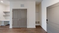 Located at 5324 Hard Scrabble Road in Blythewood, SC, this thoughtfully designed two-bedroom, two-bathroom residence offers a comfortable and modern living experience across a single floor. The interior is finished with a clean, neutral palette of crisp white walls and warm wood-look flooring throughout the main living areas, creating a bright and welcoming ambiance.

The kitchen is outfitted with gray shaker-style cabinetry, white quartz countertops, a light blue subway tile backsplash, and a full suite of stainless steel appliances including a range, over-the-range microwave, and refrigerator. Track lighting adds a contemporary touch overhead.

The living area features hardwood-style flooring, a built-in desk with open shelving, and direct access to natural light through a glass door. The spacious primary bedroom is carpeted and filled with natural light from multiple windows, complemented by a ceiling fan. It is served by a private bathroom featuring gray vanity cabinetry, a walk-in glass shower, and wood-look tile flooring. The second bedroom is equally well-lit and carpeted. The second bathroom offers a full tub-shower combination with brushed nickel fixtures.

Both closets are walk-in spaces equipped with multi-tier wire shelving systems, providing ample storage. A built-in mudroom-style nook with hooks and cubbies adds everyday practicality to this well-rounded residence.