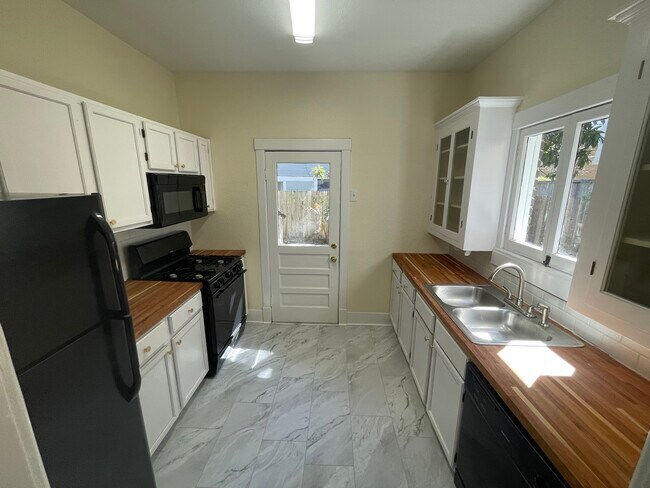 Fully remodeled kitchen with access to backyard - 411 Peden St