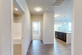 This thoughtfully designed 2-bedroom, 2-bathroom single-floor residence offers a comfortable and functional layout with modern finishes throughout. The open-concept kitchen and living area serves as the heart of the home, featuring rich dark wood cabinetry, stainless steel appliances including a refrigerator with ice maker, electric range, and built-in microwave, complemented by a large center island with a light countertop and pendant lighting overhead. Durable wood-style flooring runs through the main living areas, while large windows and vertical blinds allow for generous natural light.

The living room offers a bright, open feel with multiple windows providing outdoor views. Both bedrooms are carpeted and well-proportioned, with the primary bedroom offering ample space. The secondary bedroom includes a sliding closet door with built-in rod storage and ceiling fan. The two bathrooms are finished with dark wood vanities, light countertops, large mirrors, and a full tub-shower combination.

A dedicated laundry room houses a full-size side-by-side washer and dryer, adding everyday convenience. The overall aesthetic is clean and contemporary, with neutral wall tones, white trim, and consistent finishes that create a cohesive and inviting atmosphere throughout the space.