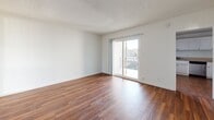 Located at 760 Earlham St in Pasadena, CA, this one-bedroom, one-bathroom residence offers a thoughtfully designed single-floor layout. Rich hardwood flooring flows consistently throughout the space, lending warmth and cohesion to every room.

The combined living and dining area is bright and open, anchored by a sliding glass door that connects seamlessly to a private balcony and floods the interior with natural light. A textured ceiling adds architectural character to the main living space, while a wall-mounted heater provides functional comfort.

The kitchen is well-appointed with white cabinetry, granite-style countertops, and stainless steel appliances including a gas range, dishwasher, and microwave — ideal for everyday cooking.

The generously sized primary bedroom features a ceiling fan with light fixture, a wall-mounted air conditioning unit, and a window with vertical blinds offering views of surrounding greenery. Four closets throughout the unit provide ample storage.

The bathroom is neatly finished with white cabinetry, a granite-style vanity countertop, and a tub/shower combination enclosed by sliding glass doors and accented with stone tile surround. A frosted privacy window brings in natural light while maintaining seclusion.
