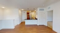 Located at 1194 Blue Ridge Ave in Crozet, Virginia, this single-floor residence offers a thoughtfully designed open-concept layout with a clean, modern aesthetic throughout. The living area features warm hardwood-style flooring and crown molding, seamlessly connecting to the kitchen, which is a standout feature of the space. The kitchen is equipped with rich wood cabinetry, dark granite countertops, a stainless steel refrigerator, range, microwave, and dishwasher. A peninsula island with pendant lighting above and an undermount sink serves as a natural gathering point and provides additional prep space.

The bedrooms are carpeted for comfort and each includes a ceiling fan with a light fixture. Natural light filters in through windows, enhancing the bright, neutral color palette found throughout. A spacious walk-in closet with wire shelving offers generous storage for the primary bedroom.

Two full bathrooms are present — one featuring a soaking tub and shower combo with hardwood-style flooring and a wood-toned vanity, and the other with a walk-in shower. Both bathrooms are finished with neutral countertops and ample vanity storage.

A dedicated laundry area houses a front-loading washer and provides additional utility space. The overall ambiance is clean, functional, and move-in ready, well-suited for comfortable everyday living in the Crozet community.