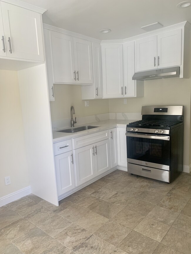 Kitchen with stove & new cabinets - 7957 5th St