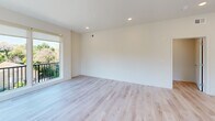 Located at 23 Rock Hill Rd in Bala Cynwyd, PA, this well-appointed 2-bedroom, 3-bathroom residence offers a clean, modern aesthetic throughout its thoughtfully designed single-floor layout. Light hardwood flooring flows seamlessly through every room, complementing the crisp white walls and recessed lighting that give the space a bright, airy feel.

The open-concept kitchen and living area serves as the heart of the home, featuring a large quartz-topped island with an undermount sink, sleek gray cabinetry, white subway tile backsplash, stainless steel appliances, and a contemporary pendant light. A wide window frames a lush, green neighborhood view, filling the space with natural light.

The living area extends to a private balcony accessed through floor-to-ceiling sliding glass doors, offering sweeping views of the tree-lined surroundings — a standout feature of the residence.

The generously sized primary bedroom includes large windows with garden views and ample room to furnish comfortably. The second bedroom features a double-door closet and abundant natural light. A dedicated hallway closet provides additional storage.

All three bathrooms are finished in a crisp, contemporary style with dark tile flooring, white vanities with quartz countertops, and clean fixtures. One bathroom includes a soaking tub with tiled surround, while another features a glass-enclosed shower.