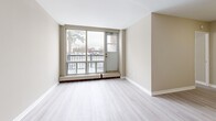 Located at 280 Wentworth St W in Oshawa, Ontario, this well-appointed 3-bedroom, 1-bathroom multi-level unit offers a thoughtfully laid-out living space spread across two floors. The main floor features an open-concept combined dining and living area finished with light vinyl plank flooring and neutral warm-toned walls, creating a bright and welcoming atmosphere. Large sliding glass doors in the living area lead directly to a private balcony, offering views of mature trees and the surrounding neighbourhood. The kitchen is outfitted with crisp white cabinetry, marble-style countertops, a stainless steel refrigerator, and a stainless steel stove, presenting a clean and modern aesthetic. Upstairs, three bedrooms provide comfortable accommodations, each featuring light vinyl flooring, warm neutral walls, and generously sized windows that bring in natural light. The primary bedroom includes a sliding-door closet, offering practical storage. The full bathroom is finished with clean white tile, a soaker tub, and shower combination. Baseboard heating is present throughout the bedrooms, ensuring warmth year-round. The overall design is clean, modern, and move-in ready, making this a functional and inviting multi-level home in central Oshawa.