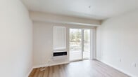 Located at 4659–4699 W Garden Springs Rd in Spokane, WA, this 2-bedroom, 2-bathroom unit offers a clean, modern aesthetic across a well-organized single-level floor plan. The interior is finished with light-toned luxury vinyl plank flooring throughout the main living areas, complemented by neutral white walls that create a bright, airy atmosphere.

The living room serves as the central gathering space, featuring a wall-mounted heating and cooling unit and a sliding glass door that opens directly onto a private balcony with views of surrounding trees. Natural light flows freely through the window and glass door, enhancing the open feel of the room.

Adjacent to the living area, the kitchen and dining space are thoughtfully appointed with medium-toned cabinetry, granite-style countertops, and black appliances including a refrigerator, range, and over-the-range microwave. Recessed lighting adds a polished touch overhead.

Both bedrooms are carpeted for comfort and include windows with blinds that allow natural light while maintaining privacy. The primary bedroom features a closet, while the second bedroom offers a cozy, versatile space. Each bathroom includes a vanity with granite-style countertops, a tub/shower combination, and wood-toned cabinetry. A utility room completes the layout.