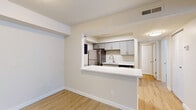 Located at 453 Golfview Blvd in Valparaiso, Indiana, this single-story, one-bedroom, two-bathroom residence offers a thoughtfully designed layout with a clean, modern aesthetic throughout. Light wood-style flooring runs continuously across all rooms, creating a cohesive and bright interior feel.

The open-concept kitchen is framed by a pass-through opening and features a white breakfast bar countertop, gray shaker-style cabinetry, stainless steel appliances including a refrigerator, and a single-basin sink — all providing both functionality and style. The adjacent living area is spacious and filled with natural light from a sliding glass door that opens to an outdoor view, complemented by vertical blinds for privacy.

The bedroom offers a comfortable footprint with a window allowing natural light, a closet with built-in shelving, and direct access to one of the two bathrooms. Both bathrooms are finished with white quartz-style countertops, gray cabinetry with brushed nickel hardware, large vanity mirrors, and light wood-style flooring. One bathroom includes a tub-shower combination with white subway tile surround, while the other features built-in open shelving for additional storage. The overall ambiance is clean, neutral, and move-in ready.