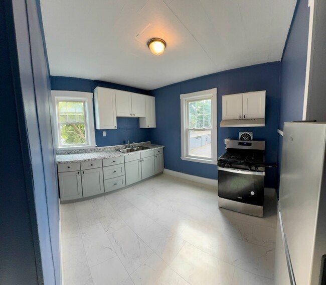 Kitchen has new cabintes counter and appliances - 26 Nye St