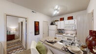 Located at 4599 N Washington St in Stillwater, Oklahoma, this one-bedroom, one-bathroom unit offers a well-designed single-floor layout that makes smart use of every square foot. The open-concept kitchen is a central highlight, featuring white cabinetry, a full suite of appliances including a refrigerator, electric range, and built-in microwave, as well as a peninsula breakfast bar that doubles as a casual dining space. The kitchen flows naturally into the living area, which is brightened by a window overlooking the exterior and features a mix of hardwood-style and carpeted flooring. The bedroom is a comfortably sized, carpeted retreat with a window that brings in natural light and includes closet access. Neutral, light-toned walls throughout the unit create a clean and airy atmosphere. The bathroom is finished with wood-style flooring, a white vanity with under-sink storage, a well-lit mirror with overhead lighting, and additional cabinet storage. The overall design is practical and cohesive, with consistent neutral tones and efficient use of space that make this unit a functional and comfortable living option in Stillwater.