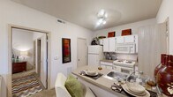 Located at 4599 N Washington St in Stillwater, Oklahoma, this one-bedroom, one-bathroom unit offers a well-designed single-floor layout that makes smart use of every square foot. The open-concept kitchen is a central highlight, featuring white cabinetry, a full suite of appliances including a refrigerator, electric range, and built-in microwave, as well as a peninsula breakfast bar that doubles as a casual dining space. The kitchen flows naturally into the living area, which is brightened by a window overlooking the exterior and features a mix of hardwood-style and carpeted flooring. The bedroom is a comfortably sized, carpeted retreat with a window that brings in natural light and includes closet access. Neutral, light-toned walls throughout the unit create a clean and airy atmosphere. The bathroom is finished with wood-style flooring, a white vanity with under-sink storage, a well-lit mirror with overhead lighting, and additional cabinet storage. The overall design is practical and cohesive, with consistent neutral tones and efficient use of space that make this unit a functional and comfortable living option in Stillwater.