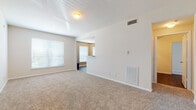This well-appointed 2-bedroom, 2-bathroom residence is thoughtfully laid out across a single floor, offering a comfortable and functional living environment. The open living area features plush wall-to-wall carpeting, neutral toned walls, and multiple windows dressed with blinds that fill the space with natural light. A ceiling fan adds comfort to the secondary bedroom, which also enjoys ample natural light and easy access to the rest of the unit. The kitchen is a standout feature, showcasing warm hardwood-style flooring, white shaker-style cabinetry, granite-look countertops, and a full suite of black appliances including a refrigerator, dishwasher, and range. Both bathrooms are finished with white cabinetry, granite-look countertops, and hardwood-style flooring; one includes a tiled tub/shower combination. A dedicated in-unit laundry area houses a full-size washer and dryer, adding everyday convenience. Storage is well-addressed throughout, including a spacious walk-in closet with wire shelving. The unit's neutral color palette and clean finishes create a bright, move-in-ready atmosphere suited for a variety of living arrangements.