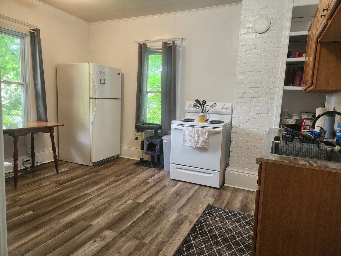 Eat in Kitchen includes table, stove, and refrigerator. - 89 S Main St