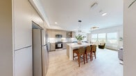 Located at 4001 198th St SW in Lynnwood, Washington, this thoughtfully designed one-bedroom, one-bathroom residence offers a contemporary living experience within a compact, efficiently laid-out floor plan. Light-toned luxury vinyl plank flooring flows throughout, creating a seamless, cohesive aesthetic across every room.

The kitchen is a standout feature, showcasing flat-panel cabinetry in a warm wood finish, sleek white quartz countertops, stainless steel appliances, and open shelving for both storage and display. A central island with bar seating serves as both a functional workspace and a natural gathering point, opening directly to the living area.

The living room benefits from a large picture window that frames expansive views of the Lynnwood cityscape and surrounding treeline, filling the space with ample natural light and a strong connection to the outdoors.

The bedroom is a comfortable retreat, featuring its own generous window with the same scenic views, a built-in closet, and crisp white walls that enhance the bright, airy atmosphere.

The bathroom is clean and well-proportioned, with light wood-tone cabinetry, a full tub-shower combination, and the same warm flooring that runs throughout the residence. The overall design balances modern finishes with a welcoming, livable feel.