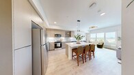 Located at 4001 198th St SW in Lynnwood, Washington, this thoughtfully designed one-bedroom, one-bathroom residence offers a contemporary living experience within a compact, efficiently laid-out floor plan. Light-toned luxury vinyl plank flooring flows throughout, creating a seamless, cohesive aesthetic across every room.

The kitchen is a standout feature, showcasing flat-panel cabinetry in a warm wood finish, sleek white quartz countertops, stainless steel appliances, and open shelving for both storage and display. A central island with bar seating serves as both a functional workspace and a natural gathering point, opening directly to the living area.

The living room benefits from a large picture window that frames expansive views of the Lynnwood cityscape and surrounding treeline, filling the space with ample natural light and a strong connection to the outdoors.

The bedroom is a comfortable retreat, featuring its own generous window with the same scenic views, a built-in closet, and crisp white walls that enhance the bright, airy atmosphere.

The bathroom is clean and well-proportioned, with light wood-tone cabinetry, a full tub-shower combination, and the same warm flooring that runs throughout the residence. The overall design balances modern finishes with a welcoming, livable feel.