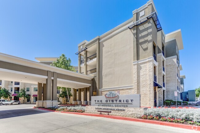 Entrance to Property & Leasing Office Parking - District at Medical Center Apartments