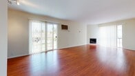 Located in the desirable West Los Angeles neighborhood of 90064, this single-floor residence at 2445 S Barrington Ave offers a clean, well-maintained living environment with a thoughtful layout. The spacious living and dining area is a standout feature, showcasing rich hardwood flooring that extends throughout the main living spaces and bedrooms. Large sliding glass doors flood the area with natural light and provide direct access to an outdoor balcony, while vertical blinds offer privacy. A fireplace anchors one end of the living room, adding warmth and character to the open space. The galley-style kitchen is efficiently designed, featuring dark granite countertops, white cabinetry, a double stainless steel sink, and white appliances including a refrigerator and electric range. Light tile flooring runs through the kitchen and connects to a dedicated closet or storage area. The bathroom is well-appointed with warm beige tile wall surrounds, a full soaking tub, a built-in niche, and matching tile floors. The bedrooms continue the hardwood flooring theme and include closet storage. Neutral, warm-toned walls throughout create a bright and cohesive atmosphere, making this a functional and inviting Los Angeles residence.