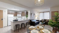 Located at 2508 SE Delaware St in Minneapolis, MN, this single-floor unit offers five bedrooms and four bathrooms within a thoughtfully designed layout. The open-concept kitchen serves as the heart of the home, featuring granite-look countertops, a center island with bar seating, warm wood-toned cabinetry, and white appliances. A skylight above the kitchen floods the space with natural light, and the layout flows seamlessly into the combined dining and living area. The dining space is anchored by a stylish geometric pendant light, while the living room offers a comfortable, welcoming atmosphere with access to natural light through curtained windows. Light wood-style flooring runs throughout the main living areas, contributing to a clean, modern aesthetic. The bedrooms are efficiently designed with light-toned walls, built-in shelving options, and direct hallway access, making each room functional and private. The bathrooms feature white countertops, wood-toned cabinetry for storage, and a clean, contemporary finish. A connecting hallway ties all rooms together, ensuring smooth circulation throughout the unit. The overall design balances modern finishes with practical, multi-occupant living in mind.