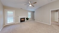 Located at 120 Edinborough Cir in Greenwood, SC, this single-story home offers a well-organized layout across three bedrooms, two bathrooms, and several functional support spaces. Neutral warm-gray tones, plush carpet, and consistent white trim create a cohesive aesthetic throughout.

The living room serves as a central gathering space, highlighted by a fireplace with a granite-surround mantle, a ceiling fan with light, and natural light from multiple windows. The galley-style kitchen is a standout feature, showcasing white shaker cabinets, granite countertops, stainless steel appliances including a refrigerator, range, and microwave, and light tile flooring.

The bedrooms are carpeted and feature ceiling fans, neutral walls, and ample natural light through blinds-fitted windows. The primary bedroom connects to a private bathroom equipped with a glass-enclosed walk-in shower, granite vanity, and tile flooring. The secondary bathroom offers a full tub-shower combination, white cabinetry, and matching granite counters. A dedicated laundry room accommodates a full-size washer and includes overhead cabinet storage and a granite folding surface. Three closets, including a walk-in, provide generous storage throughout.