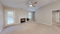 Located at 120 Edinborough Cir in Greenwood, SC, this single-story home offers a well-organized layout across three bedrooms, two bathrooms, and several functional support spaces. Neutral warm-gray tones, plush carpet, and consistent white trim create a cohesive aesthetic throughout.

The living room serves as a central gathering space, highlighted by a fireplace with a granite-surround mantle, a ceiling fan with light, and natural light from multiple windows. The galley-style kitchen is a standout feature, showcasing white shaker cabinets, granite countertops, stainless steel appliances including a refrigerator, range, and microwave, and light tile flooring.

The bedrooms are carpeted and feature ceiling fans, neutral walls, and ample natural light through blinds-fitted windows. The primary bedroom connects to a private bathroom equipped with a glass-enclosed walk-in shower, granite vanity, and tile flooring. The secondary bathroom offers a full tub-shower combination, white cabinetry, and matching granite counters. A dedicated laundry room accommodates a full-size washer and includes overhead cabinet storage and a granite folding surface. Three closets, including a walk-in, provide generous storage throughout.