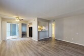 Located at 13011 Northborough Dr in Houston, TX, this 2-bedroom, 2-bathroom single-story residence offers a well-organized layout across a comfortable footprint. The interior features consistent wood-look plank flooring throughout, neutral gray-toned walls, and clean white trim, creating a cohesive and modern aesthetic.

The open-concept living and dining area is bright and welcoming, drawing natural light from large windows and a sliding glass door that opens to an outdoor balcony area. A ceiling fan adds both function and character to the space. The kitchen is positioned adjacent to the living area with a pass-through counter, white cabinetry, and black appliances including a refrigerator and range, along with access to a dedicated pantry.

The primary bedroom is generously sized, featuring a window for natural light and direct access to a spacious walk-in closet with built-in shelving rods for ample storage. The second bedroom is equally well-lit with its own window and closet access. Both bathrooms are finished with a clean, neutral palette, featuring tub-shower combinations with tiled surrounds and brushed nickel fixtures.

A dedicated entrance, hallway, and thoughtful room flow complete this efficiently designed residence, making it a practical and comfortable home in the Northborough Drive community.