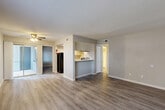 Located at 13011 Northborough Dr in Houston, TX, this 2-bedroom, 2-bathroom single-story residence offers a well-organized layout across a comfortable footprint. The interior features consistent wood-look plank flooring throughout, neutral gray-toned walls, and clean white trim, creating a cohesive and modern aesthetic.

The open-concept living and dining area is bright and welcoming, drawing natural light from large windows and a sliding glass door that opens to an outdoor balcony area. A ceiling fan adds both function and character to the space. The kitchen is positioned adjacent to the living area with a pass-through counter, white cabinetry, and black appliances including a refrigerator and range, along with access to a dedicated pantry.

The primary bedroom is generously sized, featuring a window for natural light and direct access to a spacious walk-in closet with built-in shelving rods for ample storage. The second bedroom is equally well-lit with its own window and closet access. Both bathrooms are finished with a clean, neutral palette, featuring tub-shower combinations with tiled surrounds and brushed nickel fixtures.

A dedicated entrance, hallway, and thoughtful room flow complete this efficiently designed residence, making it a practical and comfortable home in the Northborough Drive community.