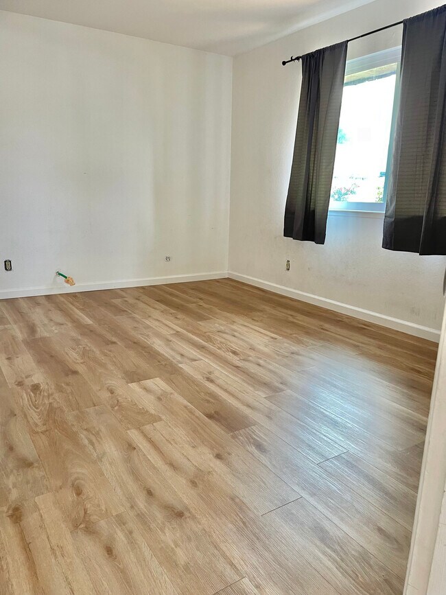 Bedroom flooring. Newly installed wood like planks - 34770 Perry Rd