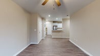 Located at 4649 Bemiss Rd in Valdosta, Georgia, this single-story home offers a clean, modern aesthetic with consistent neutral-toned walls and durable wood-look flooring carried throughout the entire layout. The open living area is generously proportioned, featuring a ceiling fan, recessed lighting, and windows that invite natural light, creating a bright and airy atmosphere. A half-wall peninsula connects the living space to the kitchen, which is a standout feature of the home. The kitchen is outfitted with crisp white shaker-style cabinetry, marble-look countertops, a stainless steel refrigerator, electric range, microwave, and dishwasher — all set against the same wood-look flooring for a cohesive feel. The bedrooms are well-sized, each equipped with ceiling fans and windows fitted with blinds that offer privacy and natural light. The bathrooms maintain the home's consistent design language, featuring marble-look countertops, white cabinetry, and tub-shower combinations. White trim and baseboards throughout provide a polished, finished look. The overall layout flows efficiently across its single floor, making it a functional and comfortable living space suited for everyday living.