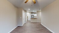 Located at 4649 Bemiss Rd in Valdosta, Georgia, this single-story home offers a clean, modern aesthetic with consistent neutral-toned walls and durable wood-look flooring carried throughout the entire layout. The open living area is generously proportioned, featuring a ceiling fan, recessed lighting, and windows that invite natural light, creating a bright and airy atmosphere. A half-wall peninsula connects the living space to the kitchen, which is a standout feature of the home. The kitchen is outfitted with crisp white shaker-style cabinetry, marble-look countertops, a stainless steel refrigerator, electric range, microwave, and dishwasher — all set against the same wood-look flooring for a cohesive feel. The bedrooms are well-sized, each equipped with ceiling fans and windows fitted with blinds that offer privacy and natural light. The bathrooms maintain the home's consistent design language, featuring marble-look countertops, white cabinetry, and tub-shower combinations. White trim and baseboards throughout provide a polished, finished look. The overall layout flows efficiently across its single floor, making it a functional and comfortable living space suited for everyday living.