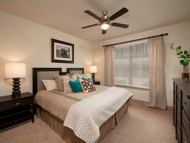 Master bedroom with ceiling fan and large window - Plantation Park