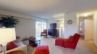 This single-floor residence offers a thoughtfully designed layout with a variety of functional living spaces. The living room is carpeted and filled with natural light from large sliding glass doors that open to an outdoor view, creating a welcoming and airy atmosphere. The space comfortably accommodates a seating area and media setup.

Adjacent to the living room, the dining area features neutral walls, carpeted flooring, a pendant light overhead, and a window with blinds that allows additional natural light. The space is well-suited for everyday dining and entertaining.

The galley-style kitchen is equipped with warm honey-toned cabinetry, ample upper and lower cabinet storage, light countertops, and white appliances including a refrigerator, electric range, and microwave. Tile flooring and a textured ceiling complete the practical and efficient workspace.

The bedroom is carpeted and benefits from a window with natural light, offering a calm and restful environment. The full bathroom features tile flooring, a wood-toned vanity with a single sink and stone-finish countertop, and a spacious layout that extends to additional fixtures.

A dedicated laundry area with an in-unit washer and an electrical panel provides added convenience. Overall, the residence presents a functional and comfortable living environment across its single level.