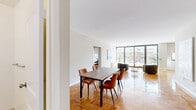 Located on the 18th floor at 185 Prospect Ave in Hackensack, NJ, this well-appointed 2-bedroom, 3-bathroom residence offers a generous and thoughtfully laid-out living space. Classic parquet wood flooring flows throughout, adding warmth and character to every room.

The open living area is a standout feature, anchored by expansive floor-to-ceiling sliding glass doors that flood the space with natural light and provide direct access to a private balcony with outdoor views. Two distinct dining areas offer flexible entertaining options, each continuing the parquet flooring motif.

The kitchen is outfitted with rich wood cabinetry, granite countertops, a decorative tile backsplash, and stainless steel fixtures, combining both function and style. Three well-maintained bathrooms include clean, bright finishes — one featuring a full tub/shower combination and another with a wood-toned vanity and large mirror.

The spacious primary bedroom offers ample room for relaxation, complemented by generous closet space. In total, five closets are distributed throughout the residence, ensuring abundant storage. The neutral white walls and clean lines throughout create a bright, versatile ambiance suited to a variety of lifestyles.