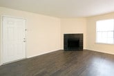 Located at 550 St. Michaels Way in Newport News, Virginia, this single-floor residence offers a well-appointed layout designed for comfortable everyday living. The open living area makes an immediate impression with rich, dark hardwood-style flooring, a sleek black fireplace as a focal point, and large windows fitted with blinds that invite an abundance of natural light. The space flows seamlessly toward a breakfast bar that connects the living area to the kitchen, which is outfitted with dark espresso cabinetry, granite-style countertops, stainless steel appliances, and durable wood-look flooring. The bedrooms are carpeted for warmth and comfort, each equipped with ceiling fans and ample natural light. One bedroom features sliding glass door access to a private outdoor area, while another opens to an in-unit laundry closet with a full-size washer and dryer. The bathroom showcases an espresso-toned vanity with granite-style countertops, a framed mirror, and a clean tub-shower combination with white tile surround. Neutral wall tones and consistent finishes throughout the home create a cohesive and move-in-ready atmosphere suited for a variety of lifestyles.