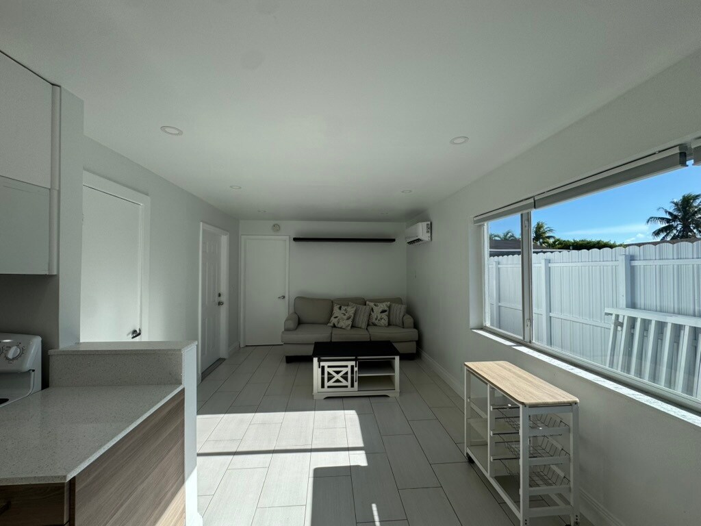 Living room and dining space. Furniture comes with apartment if desired. - 2415 Thomas St