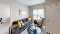This single-floor residence offers a thoughtfully designed layout that balances functionality and comfort across its living spaces. The galley-style kitchen serves as a central highlight, featuring granite-look countertops, crisp white cabinetry with modern bar-pull hardware, and a full suite of stainless steel appliances including a refrigerator, electric range, built-in microwave, and dishwasher. Light wood-style flooring runs throughout the unit, creating a cohesive and clean aesthetic.

The living area is bright and welcoming, benefiting from natural light through a large window fitted with blinds. Multiple bedrooms share a consistent design language — neutral warm-toned walls, light flooring, and windows that allow natural light to filter in. Each bedroom offers a functional layout suitable for sleeping and study.

Two full bathrooms serve the unit, each finished with granite-look vanity countertops, white cabinetry, updated light fixtures above mirrored vanities, and tile or wood-style flooring. One bathroom includes a shower-tub combo, while the other is configured as a full bath. The overall ambiance throughout the unit is clean, modern, and practical.