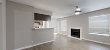 This contemporary apartment, situated at 1901 Murfreesboro Pike in Nashville, TN, offers a blend of comfort and functionality across its single-floor layout. The space showcases a variety of flooring options, with plush carpeting in bedrooms and sleek wood-look flooring in common areas, creating distinct zones within the home.

The kitchen is a highlight, featuring updated appliances, ample cabinetry in a neutral tone, and a galley-style layout that maximizes efficiency. Stainless steel appliances, including a refrigerator and range, complement the modern aesthetic.

Bedrooms are generously sized, with large windows allowing natural light to filter through horizontal blinds. Ceiling fans with integrated lighting fixtures provide both illumination and air circulation. The bathroom offers a clean, white design with a combination tub-shower unit and modern fixtures.

The living area is spacious and versatile, with a potential fireplace adding a cozy touch. Throughout the apartment, recessed lighting and ceiling-mounted fixtures ensure well-lit spaces. A walk-in closet with built-in shelving offers abundant storage solutions.

The neutral color palette, predominantly in shades of beige and white, creates a calm, cohesive atmosphere throughout the apartment. This modern living space combines practicality with style, suitable for various lifestyle needs in the heart of Nashville.