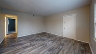 This single-floor, 2-bedroom, 2-bathroom residence at 1700 Johnson Rd in Petersburg, VA offers a practical and well-appointed layout. The living area features durable wood-style flooring, neutral-toned walls, and multiple windows fitted with blinds that allow for natural light. A ceiling fan adds comfort to the main living space, which connects to the rest of the home via a central hallway.

The kitchen is efficiently designed with white shaker-style cabinetry, light granite-look countertops, a subway tile backsplash, a stainless steel sink, and stainless steel appliances including a refrigerator and dishwasher. Light wood-style flooring continues through this space.

Both bedrooms are carpeted and feature neutral walls with windows providing natural light. The spacious primary bedroom includes two doors, one leading to a closet, offering added storage convenience.

The two bathrooms present clean, updated finishes. One features a full tub-shower combo with white subway tile surround, while the other offers a white vanity with modern hardware, a mirror, and wood-style flooring. A dedicated utility room and additional closets round out the home's storage options, contributing to an organized and efficient living environment.