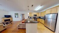 Located at 1920 Dunlap Crescent in Chester, Virginia, this single-floor home presents a well-organized layout designed for comfortable everyday living. The open-concept kitchen and living area serves as the heart of the home, where light maple cabinetry, dark granite countertops, and stainless steel appliances define a functional kitchen equipped with ample storage. A peninsula with pendant lighting bridges the kitchen to the living space, which features hardwood flooring, a fireplace, and a sliding glass door that invites natural light and provides outdoor access. An adjacent dining area, also finished with hardwood floors, comfortably accommodates a four-person table.

The home includes multiple bedrooms, each carpeted and naturally lit through windows dressed with sheer curtains. The primary bedroom offers generous closet space with double bi-fold doors. Two bathrooms serve the home, both featuring light wood vanities and tiled floors. One bathroom connects directly to an in-unit laundry room, adding everyday convenience. Throughout the home, a neutral color palette and consistent finishes create a cohesive and welcoming atmosphere suited to a range of lifestyles.