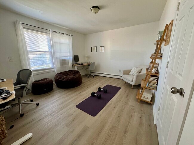 Spacious 3rd bedroom downstairs that is currently being used as an office and workout space - 138 Race St