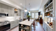 Located in Austin, TX, this 1-bedroom, 1-bathroom residence offers a thoughtfully designed open-concept layout that maximizes every square foot. The combined kitchen and living area serves as the heart of the home, anchored by a sage-green island with a crisp white countertop and built-in open shelving, illuminated by a pair of elegant pendant lights. The kitchen features floor-to-ceiling shaker-style cabinetry in a muted sage tone, stainless steel appliances including a gas range and French door refrigerator, and a classic white subway tile backsplash. Warm hardwood flooring flows seamlessly throughout the main living area, adding a natural, inviting element. The living room is bathed in natural light from large windows and a glass-paned door that opens to the exterior, creating a bright, airy atmosphere. A sculptural multi-globe chandelier serves as a striking focal point overhead. The bedroom is a serene retreat with plush carpeting, natural light from dual windows, and a dedicated closet. The full bathroom offers a long vanity with dual sinks, dark cabinetry, marble-look tile flooring, and a full tub-shower combination with white subway tile surround.