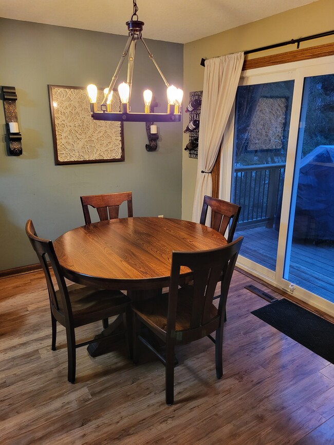 Dining room with patio door to large deck overlooking the backyard - 8460 Red Oak Dr