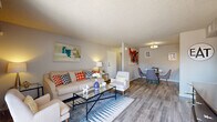 Located in Peoria, Arizona, this single-floor, 2-bedroom, 1-bathroom residence offers a thoughtfully designed layout across a comfortable footprint. The living room serves as the heart of the home, featuring wood-look flooring, a textured ceiling, and a sliding glass door that fills the space with natural light and provides outdoor access. The adjacent dining area is defined by a stylish flush-mount light fixture and flows seamlessly from the living space, making it ideal for everyday meals or entertaining.

The galley-style kitchen is outfitted with white cabinetry, quartz-style countertops, a gray subway tile backsplash, and stainless steel appliances including a refrigerator, dishwasher, and range. The primary bedroom is a well-sized retreat with wood-look flooring and natural light from a side window. The second bedroom also features wood-look flooring and a window, offering versatile use of space.

The bathroom includes a single-sink vanity with white cabinetry, a large mirror, and a shower-tub combination. A hallway and closet round out the functional layout. Neutral gray tones and consistent flooring throughout create a cohesive, modern ambiance across all rooms.